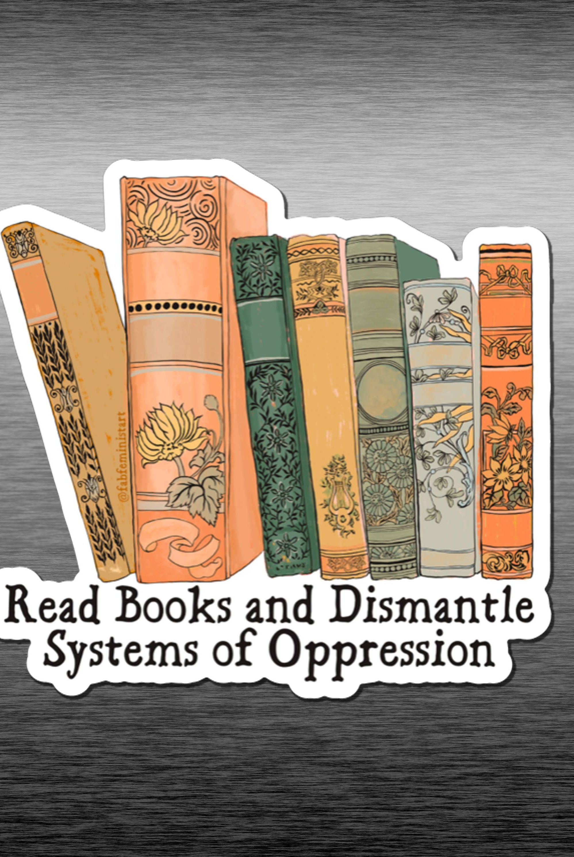 A magnet featuring a graphic of various books with the phrase 'Read Books and Dismantle Systems of Oppression' against a grey background.