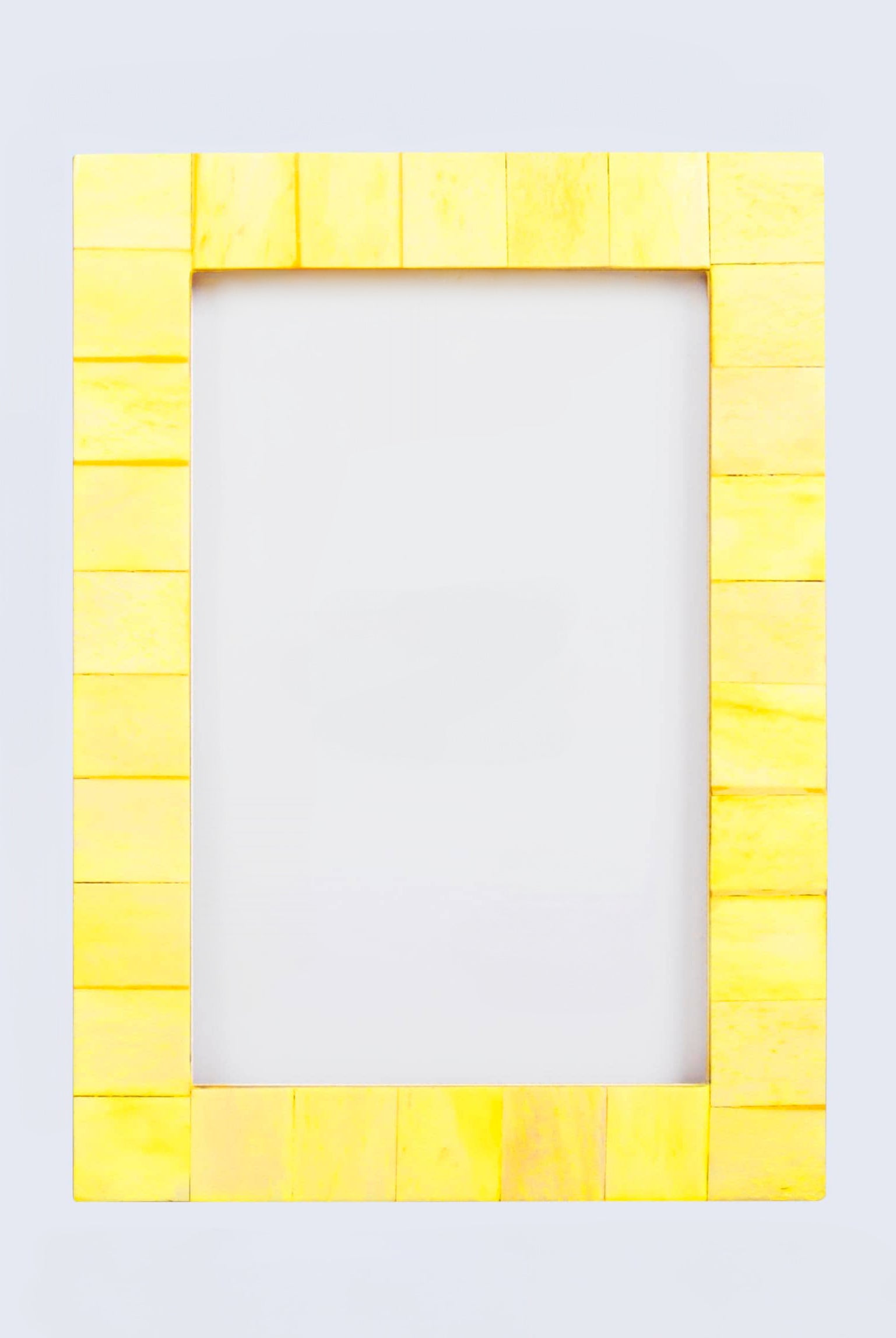 Yellow frame made of small rectangular blocks on a light gray background