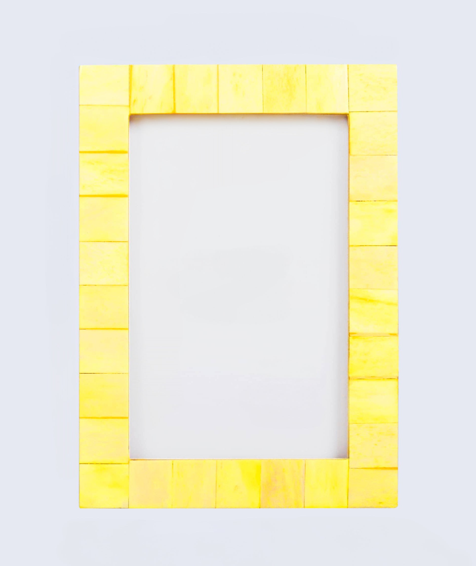 Yellow frame made of small rectangular blocks on a light gray background