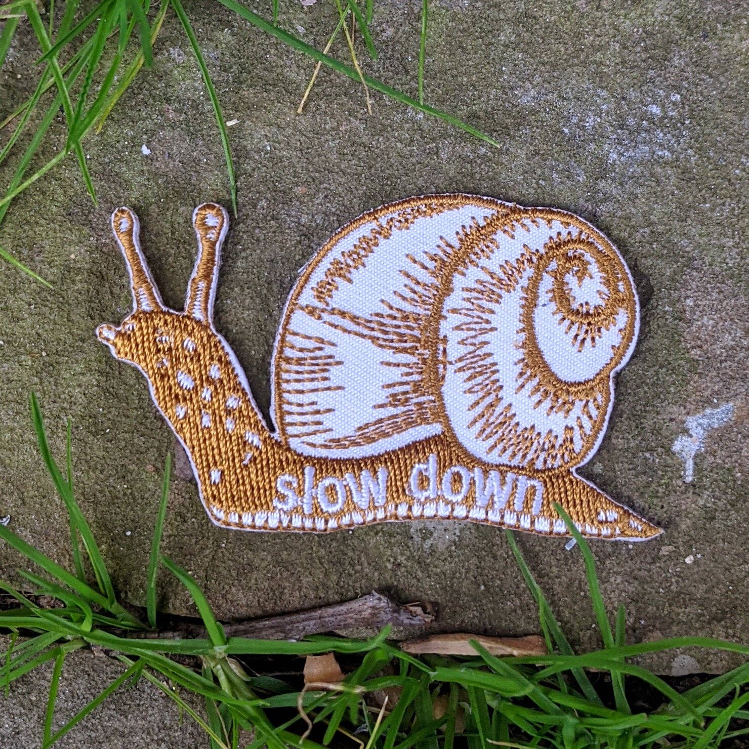 Iron-on patch, slow down snail - brown 1.6" x 2.6" - Gather Goods Co.