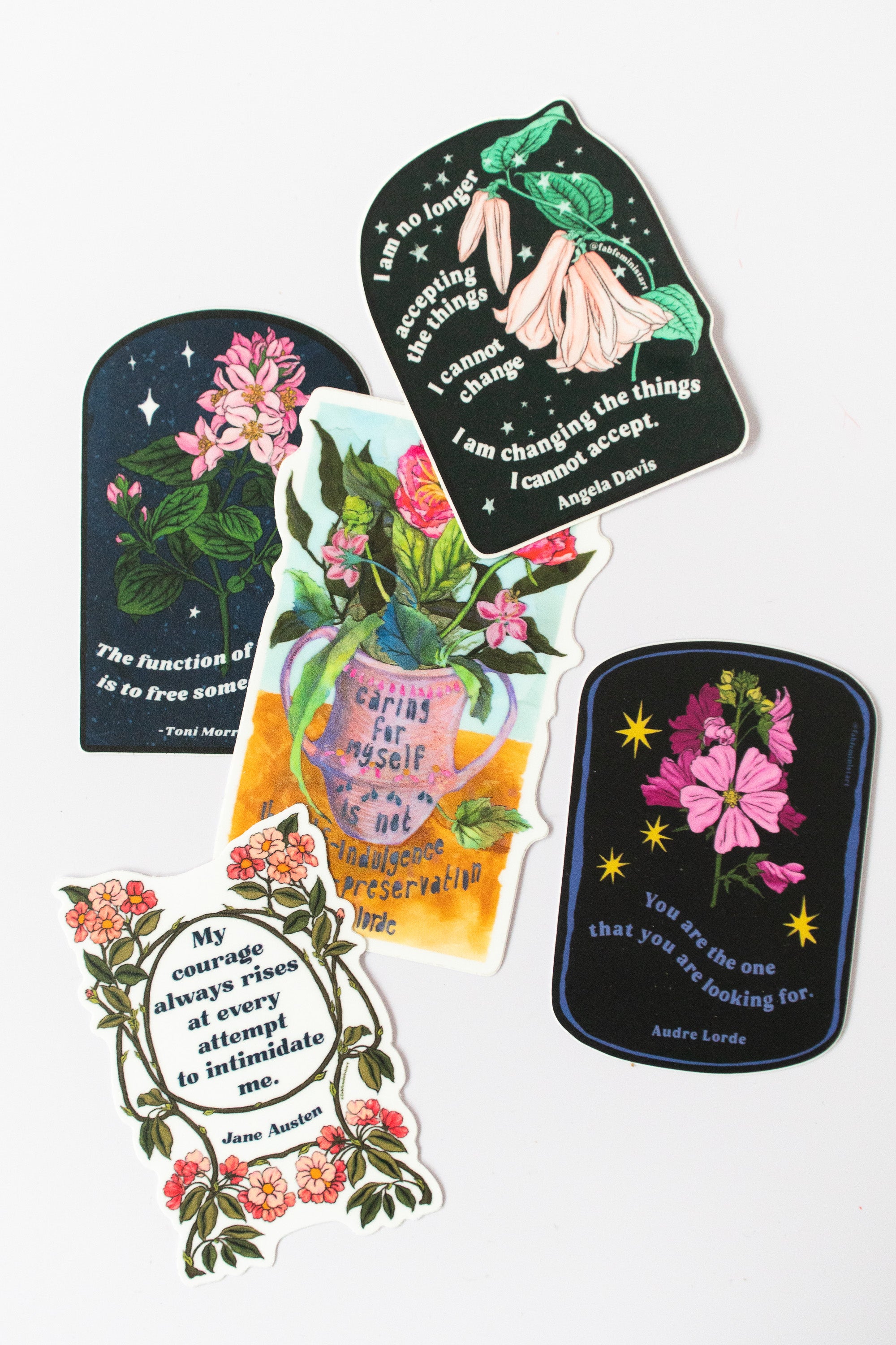 A group of feminist stickers with flowers and quotes
